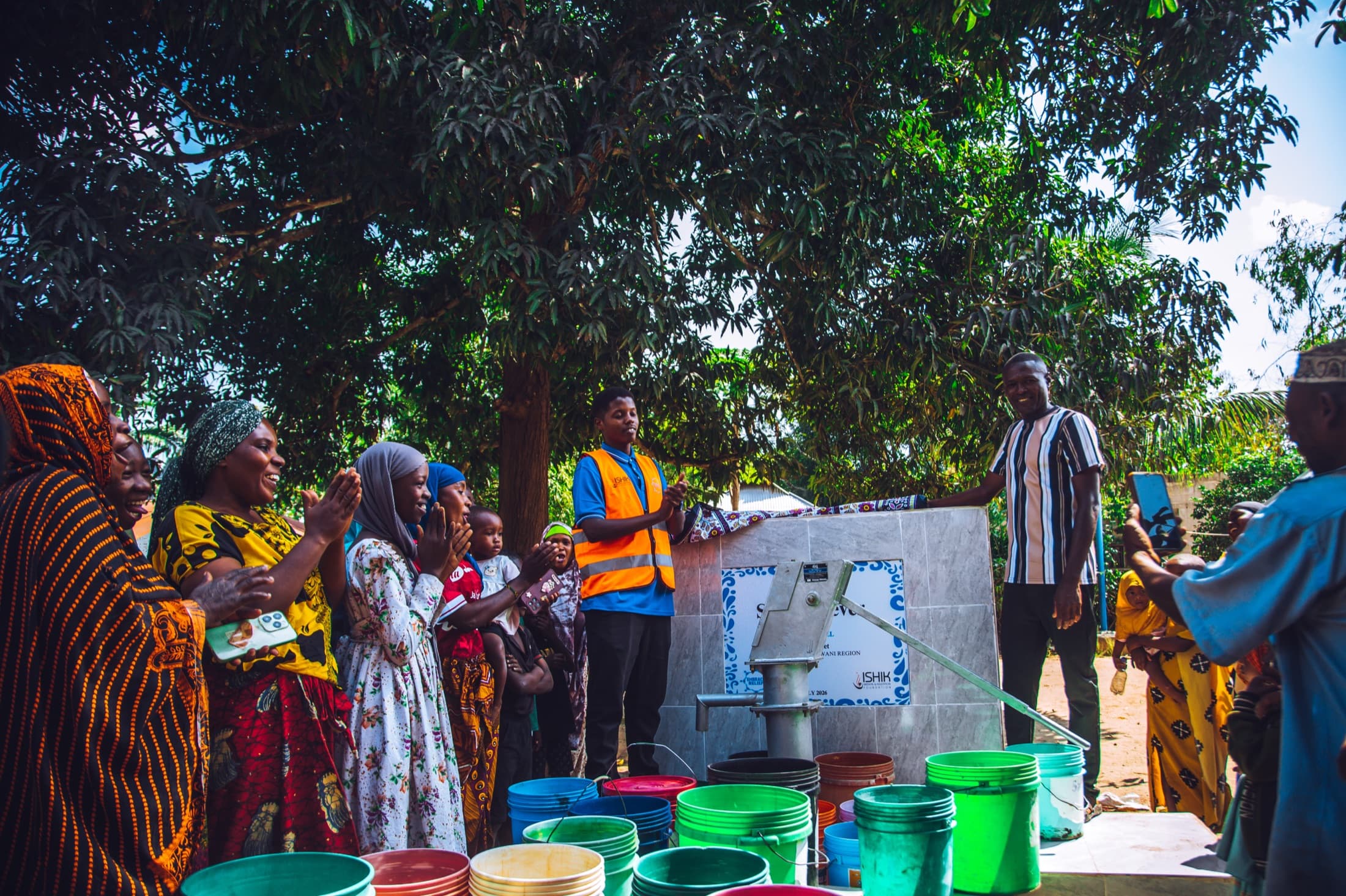 Community gathered around a completed Embrace Relief water well