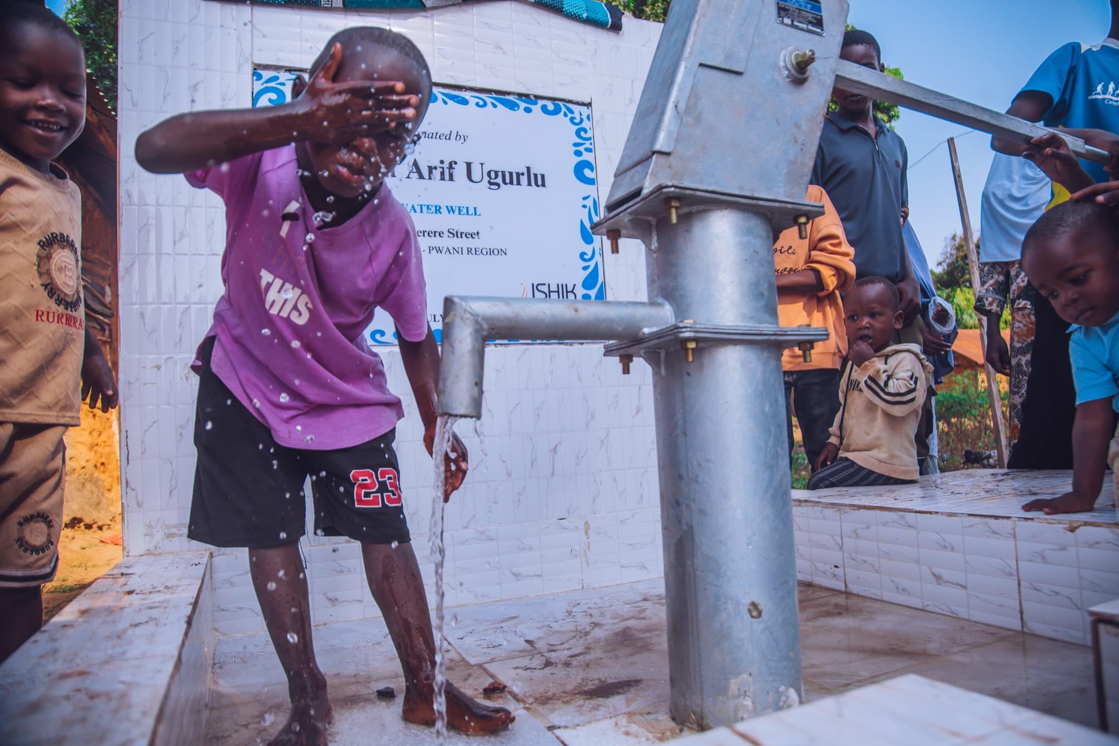 A child using a restored community water point