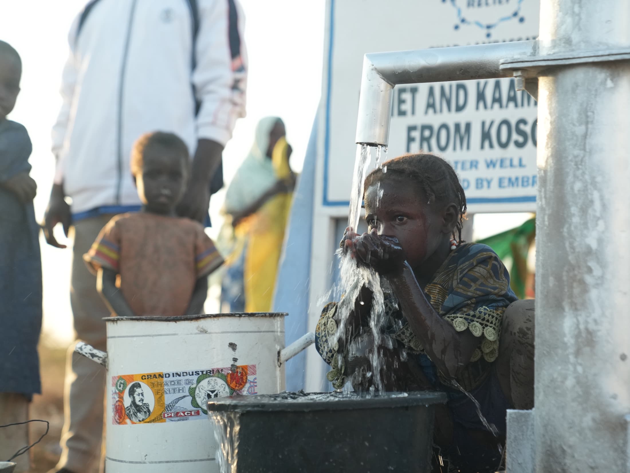 Child collecting safe water from a completed community well