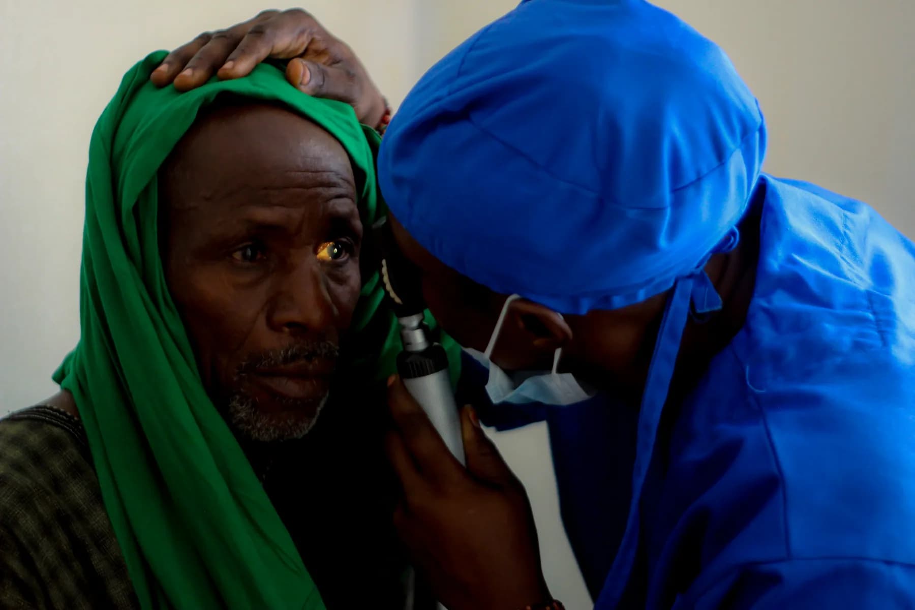 A clinician examining a patient during eye-care outreach