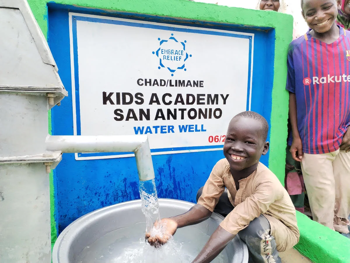 Community members accessing clean water from a well in Africa